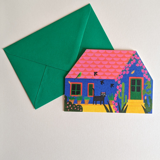 Cette magnifique carte en forme de maison est inspirée de la célèbre « Casa Azul » de Frida Kahlo. Vous pouvez écrire un message à l'intérieur de la carte.