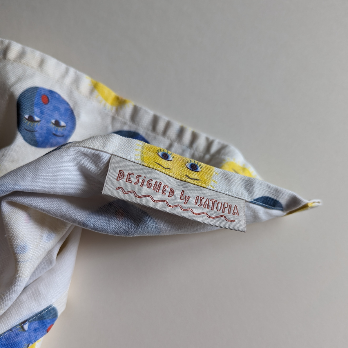 Ce torchon est fabriqué à partir d'un mélange de fibres naturelles de lin et de coton, ce qui lui donne une texture agréable et épaisse. L'impression numérique des illustrations originales d'Isabelle Gelot garantit une qualité visuelle nette et précise.