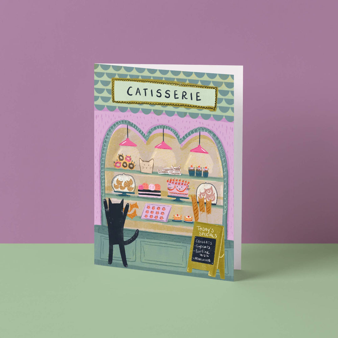 Carte de vœux illustrée avec un chat devant une pâtisserie, illustration originale Niaski.