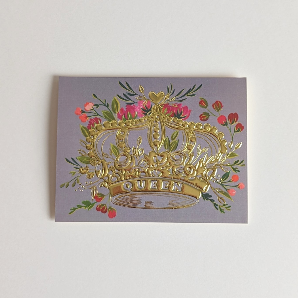Une couronne entourée de fleurs, symbolisant la grâce et la grandeur a été gaufrée à la feuille d’or pour la rendre encore plus luxueuse.