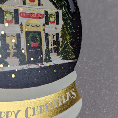 Carte Happy Christmas découpée en forme de boule à neige. De la dorure rend cette carte encore plus féérique. Dessinée par The First Snow.