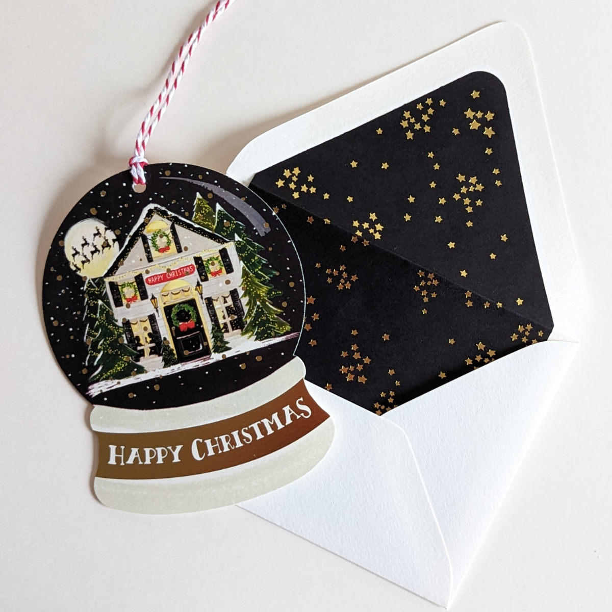 Carte Happy Christmas découpée en forme de boule à neige.  Dessinée par The First Snow.